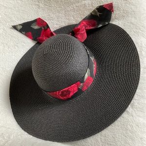 Black wide brim hat with attached floral ribbon.